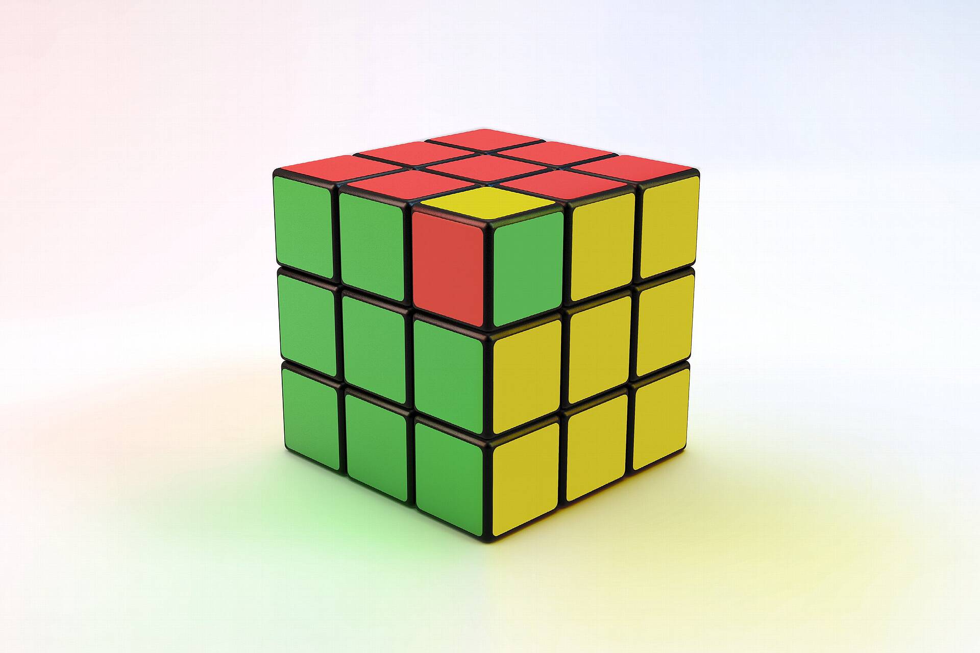Zauberwürfel beziehungsweise Rubik's Cube in den Farben der Ampelkoalition Rot, Grün und Gelb.